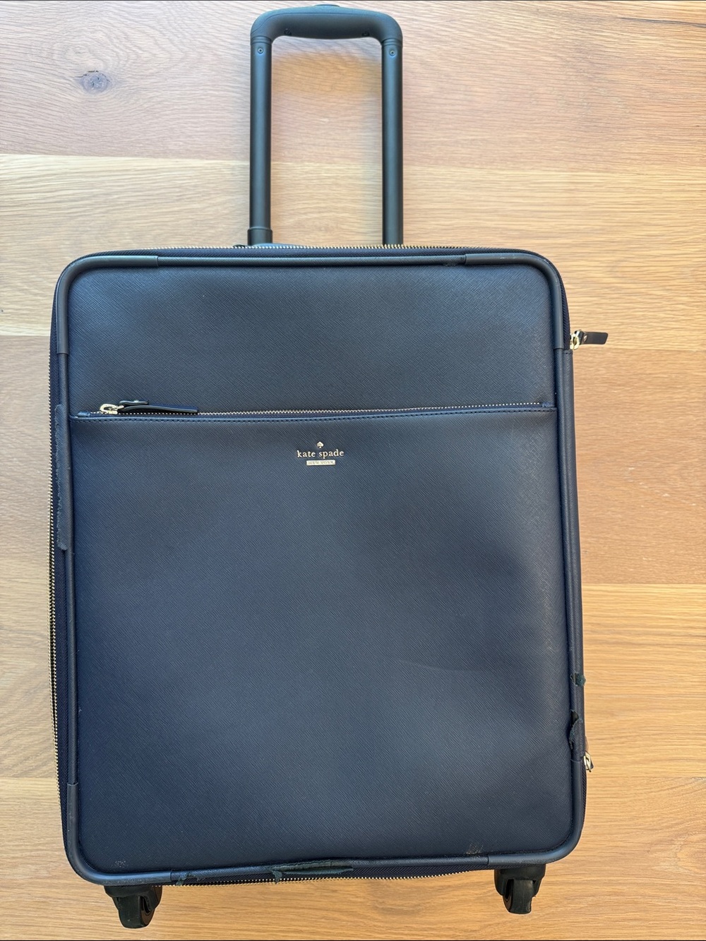 kate spade navy leather wheeled carry-on suitcase with gold logo